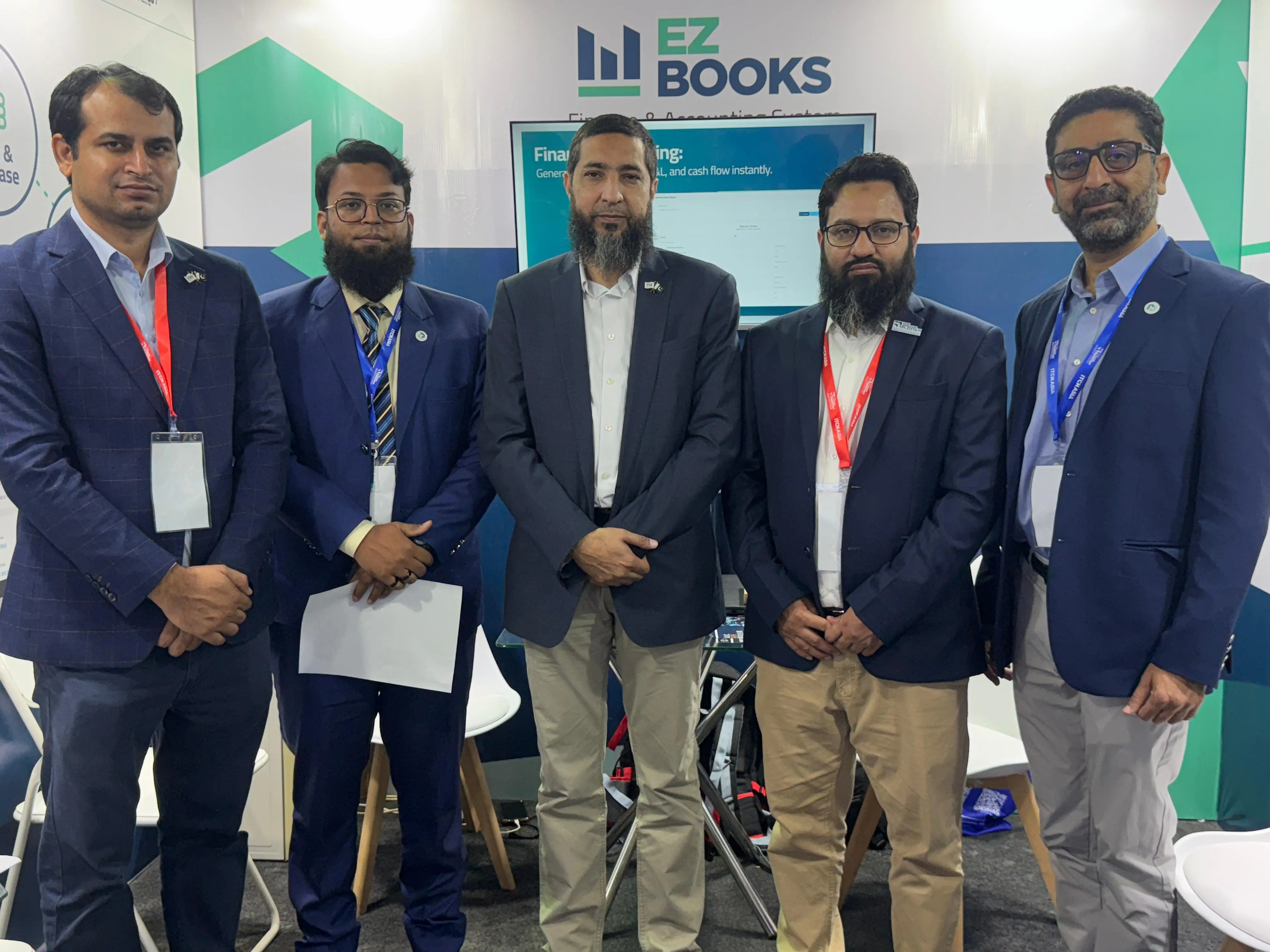 Group of professionals at the EZ Books booth during ITCN Asia 2025.